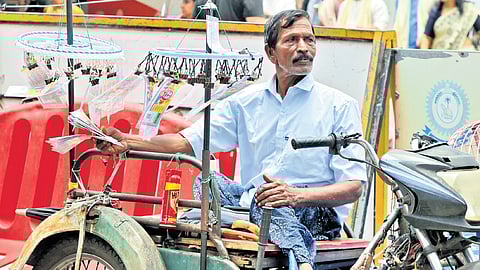 A differently abled person sells lottery in front of Sree Padmanabhaswamy Temple in Thiruvananthapuram on Tuesday 