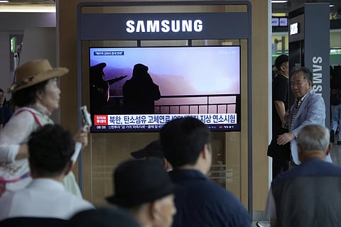 A TV screen shows an image of North Korean leader  Kim Jong Un, second from right, supervising a test of a new rocket engine during a news program at the Seoul Railway Station in Seoul, South Korea, Tuesday, Sept 9, 2025
