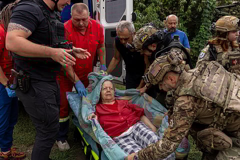 Police officers and medics evacuate Olha Trush, 86 from the village of Yarova, that was hit by Russian aerial strike, which killed dozens of civilians, in Sloviansk, Donetsk region, Tuesday, Sept.9, 2025.