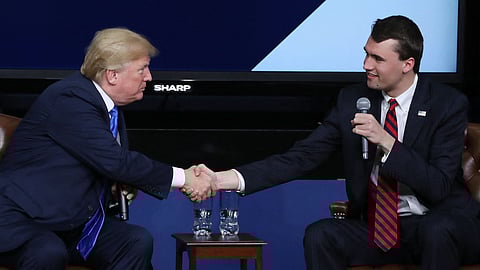 US President Donald Trump shakes hands with conservative activist Charlie Kirk at a forum dubbed the Generation Next Summit at the White House on March 22, 2018 in Washington, DC. 