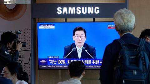 People watch a TV screen showing the live broadcast of South Korean President Lee Jae Myung's press conference at the Seoul Railway Station in Seoul, South Korea, Thursday, Sept. 11, 2025
