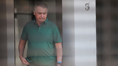 Brazil's former President Jair Bolsonaro stands at the entrance of his home where he is under house arrest in Brasilia, Brazil, Thursday, Sept. 11, 2025. 