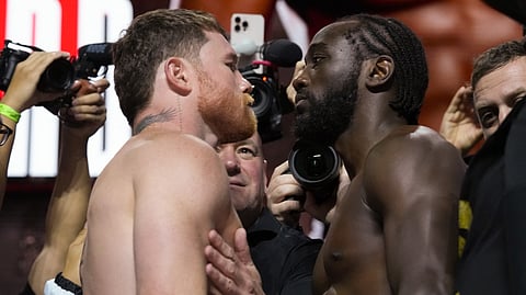 Undisputed super middleweight champion Canelo Alvarez (L) faces off against Terence Crawford during a weigh-in ahead of their undisputed super middleweight title fight at T-Mobile Arena on September 12, 2025 in Las Vegas, Nevada. 