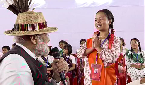 Prime Minister Narendra Modi interacts with a young girl during meeting with violence-affected people at relief camp, in Churachandpur, Manipur.