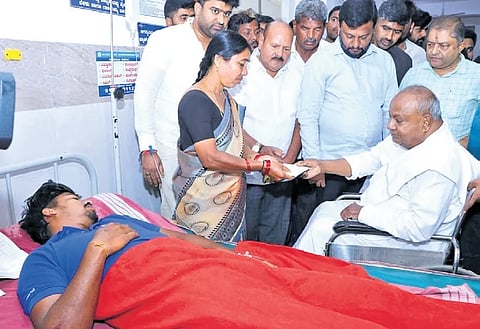 Former prime minister HD Devegowda meets the kin of the victims in Hassan on Saturday.