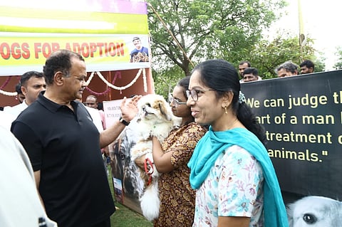 Minister Komatireddy Venkat Reddy talking with dog lovers at Dog adoption program in Nalgonda on Saturday.