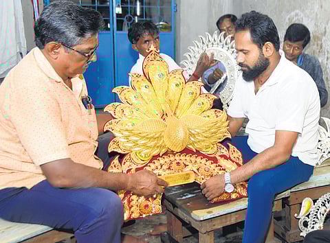 Silver filigree artisans checking out the deities’ ornaments 