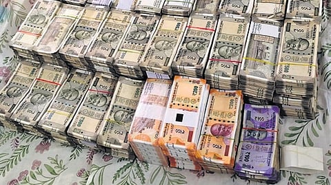 Bundles of cash seized from the tainted TGSPDCL ADE in Hyderabad on Tuesday.