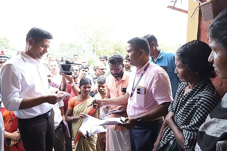 Chief Electoral Officer Rathan U. Kelkar verifying documents during a visit to homes at Anavai hamlet in Attappadi.