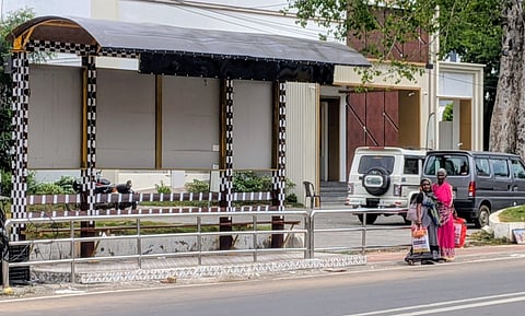 The bus shelter at Irwin bridge stop in Thanjavur where the railings are yet to be removed, forcing commuters to wait outside the shelter.