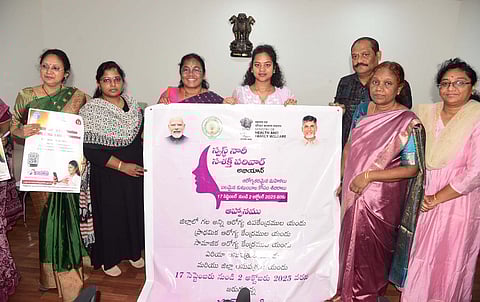 Anakapalli Joint Collector M. Jahnavi unveils the wall poster for the Swasth Nari Shakti Parivar Abhiyan programme at the Joint Collectors office in Anakapalli on Tuesday.