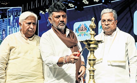 Karnataka DCM DK Shivakumar lights the lamp as CM Siddaramaiah and Tourism Minister HK Patil look on at the 55th FHRAI Annual Convention 2025.