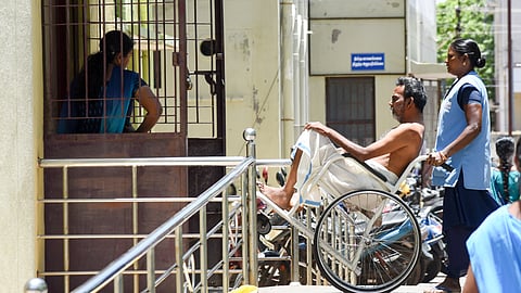 A patient being taken in a wheelchair at MGMGH.