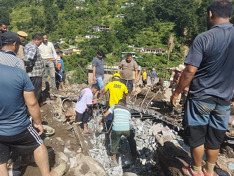 SDRF personnel rescue the body of a villager from the debris during a search operation.