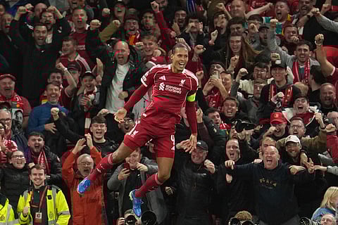 Liverpool's Virgil van Dijk celebrates after scoring his side's third goal during the Champions League opening phase soccer match between Liverpool and Atletico Madrid on Wednesday, Sept. 17, 2025.