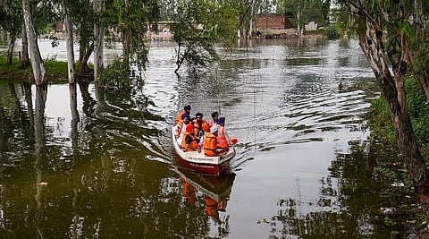 Officials inspect a flood-affected area in a boat, at Ajnala in Amritsar district, Punjab, Saturday, Sept. 6, 2025.