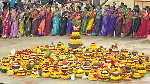Women form circles around them, singing folk songs and moving gracefully in unison, marking the farewell to the floral goddess.