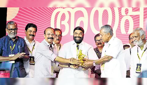 Travancore Devaswom Board president P S Prasanth handing over an Ayyappa Idol to Chief Minister Pinarayi Vijayan during the inauguration of the Global Ayyappa Sangamam at Pampa on Saturday.