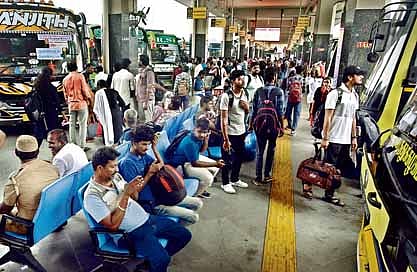 Public waiting to board the bus to visit their respective hometowns at Kilambakkam bus terminus. 