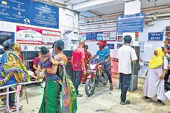 A man enters the hospital with his bike taking a shortcut, amid protests by the security staff 