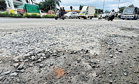 The bad condition of Mysuru Road poses a danger to motorists near Nayandahalli flyover in Bengaluru on Tuesday