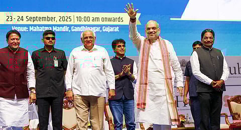 Union Home Minister Amit Shah waves to the gathering as Gujarat Chief Minister Bhupendra Patel looks on during the state's 'Startup Conclave 2025', in Gandhinagar, Gujarat, Tuesday, Sept. 23, 2025. 