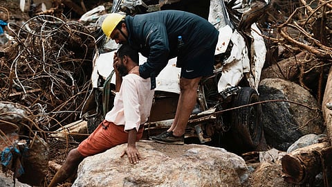 A rescue worker consoles a survivor after the deadly landslides in Wayanad landslides last year
