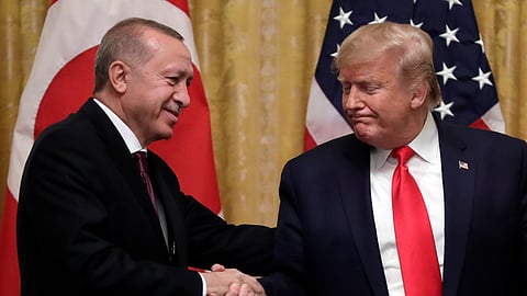 US President Donald Trump (R) shakes hands with Turkey's President Recep Tayyip Erdogan after a news conference in the East Room of the White House, Nov. 13, 2019, in Washington.