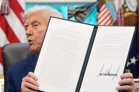 President Donald Trump holds a signed executive order regarding TikTok in the Oval Office at the White House, Thursday, Sept. 25, 2025, in Washington.