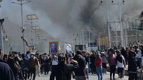 In this photo from Sept. 24, 2025, smoke rises from buildings including the local office of the BJP set ablaze during protests in Leh town, Ladakh on Wednesday.