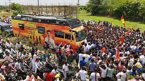 People cheer as Tamilaga Vetri Kazhagam (TVK) Founder Vijay's convoy arrives at the venue of a public rally, in Namakkal district, Tamil Nadu, Saturday, Sept. 27, 2025. 