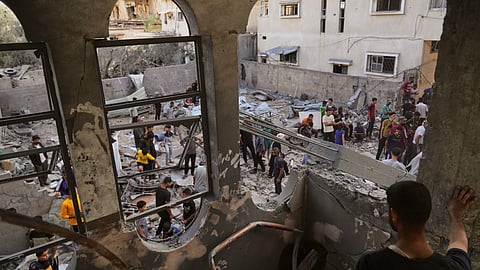 Palestinians survey the aftermath of an Israeli military strike on the Abu Dahrouj family home in Zawaida, central Gaza Strip, Thursday, Sept. 25, 2025. 
