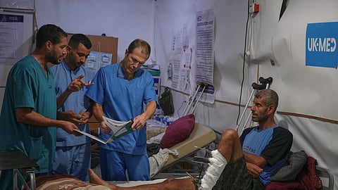 Dr. Paul Ransom of the British humanitarian medical NGO UK-Med, assisted by local medical staff, treats patients at a field hospital in Muwasi, near Khan Younis in the southern Gaza Strip, Saturday, Sept. 27, 2025.