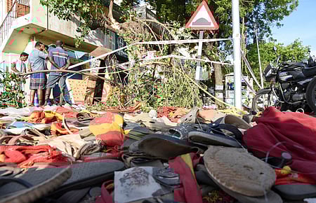 Party flag and chappels remain after the rampage at TVK leader campaign rally in Karur on Sunday