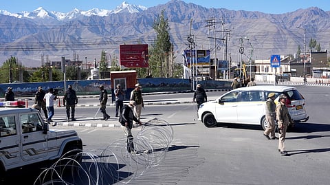 Security personnel stand guard on a road amid a curfew, in Leh, Ladakh, Sunday, Sept. 28, 2025