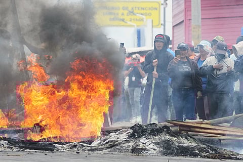 Demonstrators block a road to protest diesel price hikes following President Daniel Noboa's fuel subsidy cuts in Tabacundo, Ecuador, Tuesday, Sept. 23, 2025.