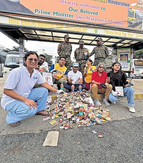 Volunteers as part of the gutkha plog pose with the sackful of gutkha packest they collected on Sunday 