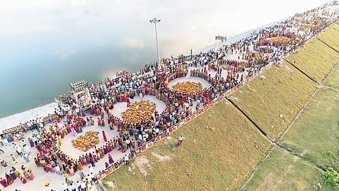 Women dressed in colourful attire sing traditional folk songs as they bid farewell to Bathukamma in Husnabad on Monday.