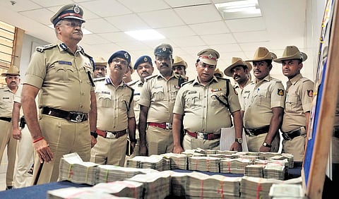 City Police Commissioner Seemanth Kumar Singh inspects the money recovered in Bengaluru on Sunday 