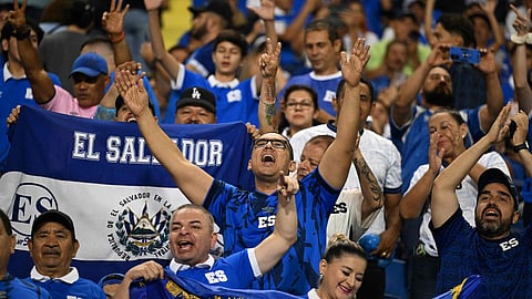 El Salvador fans cheer during the 2026 FIFA World Cup CONCACAF qualifier football match between El Salvador and Suriname at the Cuscatlan Stadium in San Salvador on September 8. 