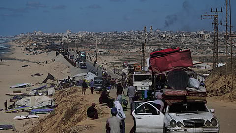 Displaced Palestinians flee northern Gaza carrying their belongings along the coastal road near Wadi Gaza, Wednesday, Oct, 1, 2025.