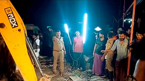 Police and rescue workers conduct an operation after three workers get trapped in a hotel waste tank during cleaning, in Idukki, Kerala, Wednesday, Oct. 1, 2025.