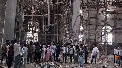 Worshippers stand inside the Menjar Shenkora Arerti Mariam Church under construction that collapsed in Arerti, Amhara region of northern Ethiopia, on Wednesday, Oct. 1, 2025.