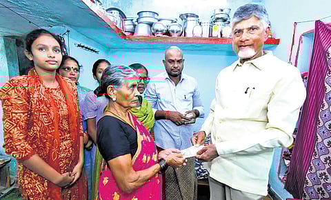 CM Nara Chandrababu Naidu handing over the pension amount to an old woman during the Pedala Sevalo programme at Datti in Vizianagaram district 