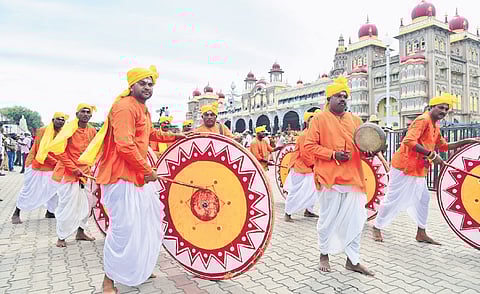 Folk artistes perform during the Dasara procession in Mysuru on Thursday