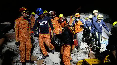 Rescuers bring down a body they recovered from the ruins of a collapsed building, Wednesday, Oct. 1, 2025 after a strong earthquake struck Bogo city, Cebu Province, Central Philippines.