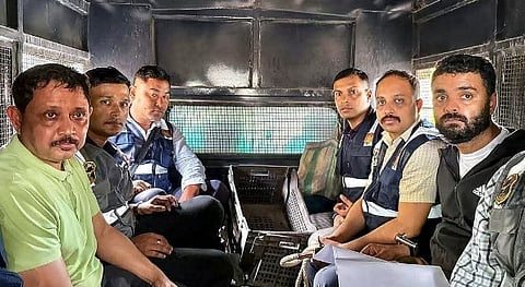 North East India Festival (NEIF) chief organiser Shyamkanu Mahanta and his manager Siddhartha Sharma, alleged to be involved in the death of legendary singer Zubin Garg in Singapore, are brought to the CID office inside a police vehicle following their arrest from Delhi, in Guwahti, Assam, Wednesday, Oct. 1, 2025.