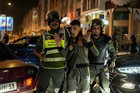A boy is detained as youth led protests calling for healthcare and education reforms turned violent, in Sale, Morocco, Wednesday, Oct. 1, 2025.