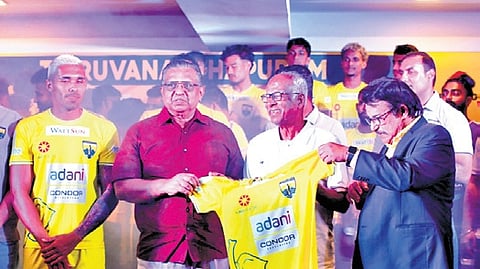 Former state police chief Jacob Punnoose handing over the Kombans FC jersey to franchise owner T J Mathew