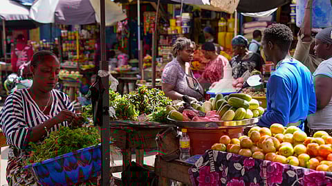 FILE - A vegetable seller sorts fresh produce at a market in Conakry, Guinea, Sept. 19, 2025 